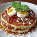 Stack of Pancakes with Banana Slices Mint Leaves and Coconut