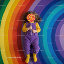 Child with Large Lollipop on Colorful Rainbow Floor