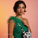 Elegant Woman in Green Dress with Feather Details and Cowprint Bag