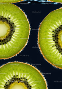 Close up of fresh green kiwi slices against dark background