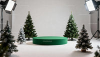 Minimalist Christmas display with green podium and fir trees
