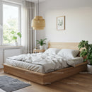 Minimalist bedroom with wooden bed and green plants