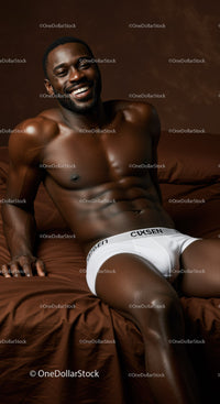 Smiling muscular man relaxing on brown bed linens