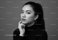 Elegant Black and White Portrait of a Confident Woman with Hoop Earrings