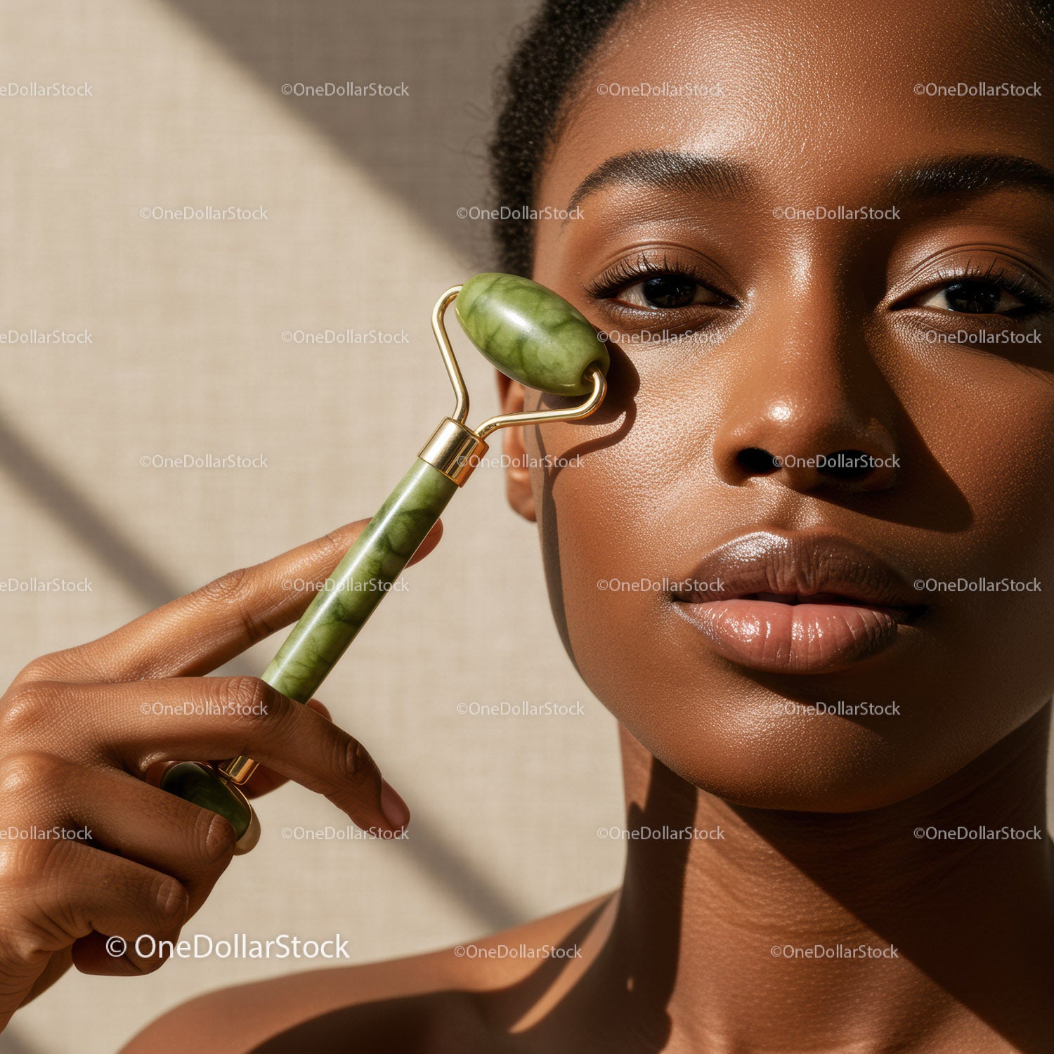 Close-up of a Woman Using Jade Roller for Facial Skincare