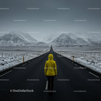 Lonely Traveler in Yellow Jacket on Snow-Covered Road