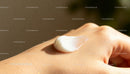 Close-up of moisturizing cream on hand skin