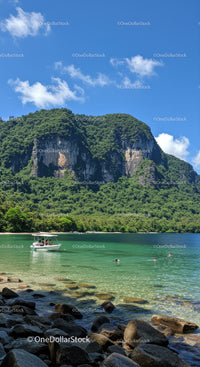 Tropical Mountain Cliffside with Clear Water and Boat Scene