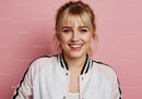 Portrait of a Smiling Young Woman with Blonde Hair Against Pink Background