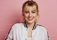Portrait of a Smiling Young Woman with Blonde Hair Against Pink Background