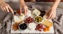 Gourmet Cheese Platter with Grapes and Assorted Dried Fruits
