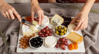Gourmet Cheese Platter with Grapes and Assorted Dried Fruits