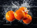 Vibrant Fresh Oranges Splashing into Water