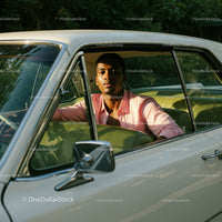 Young Man in Pink Shirt Sitting in Vintage Car on a Sunny Day