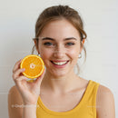Bright Smiling Woman with Fresh Orange Slice for Healthy Lifestyle