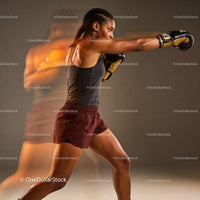 Focused boxer throwing punch in dynamic motion blur