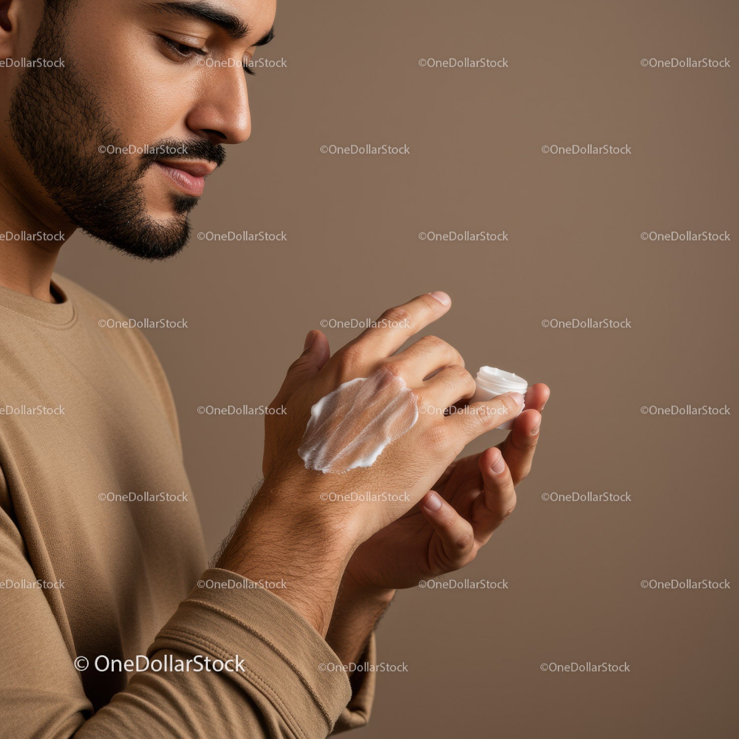 Man Applying Cream for Skincare Routine in Minimalist Setting