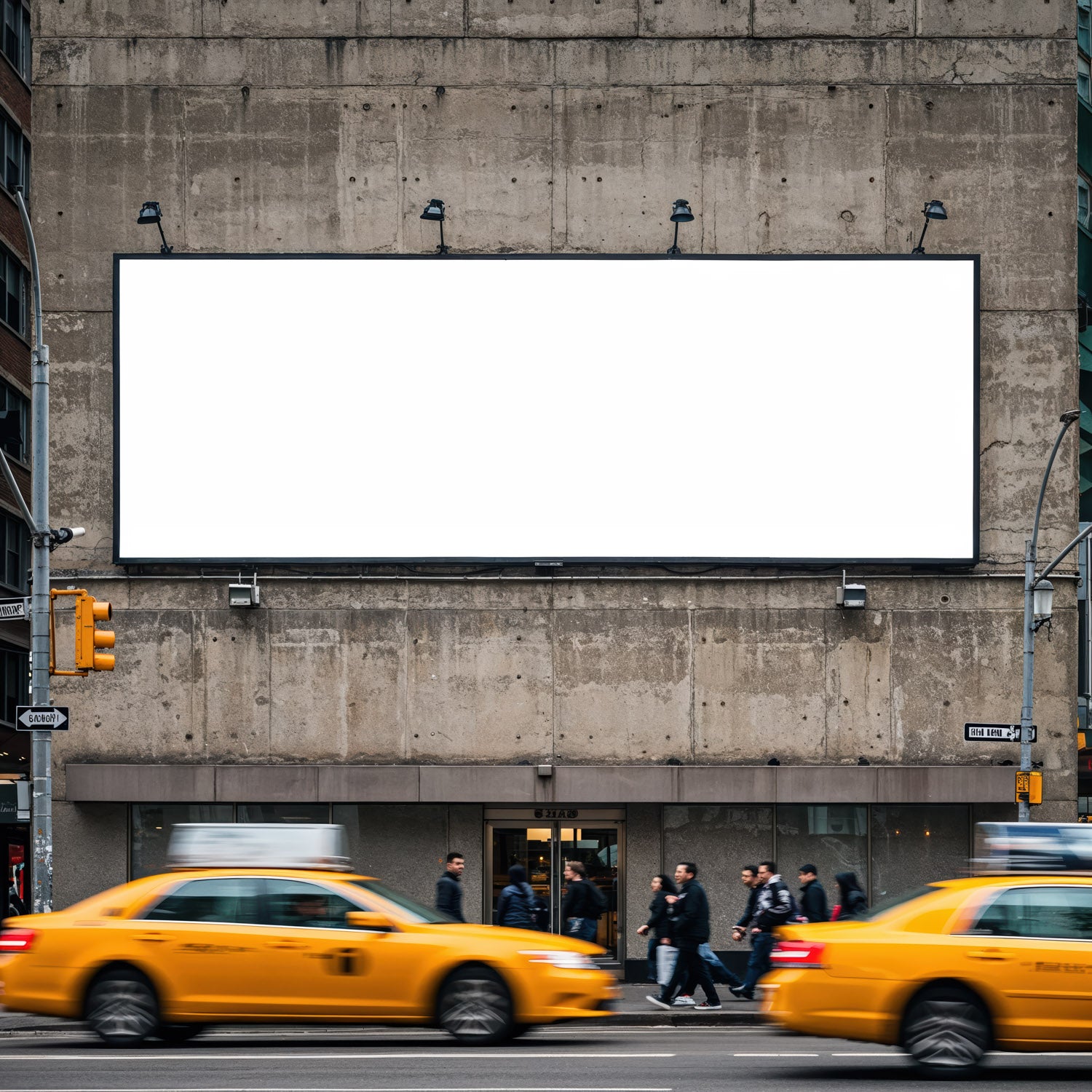 Busy street with yellow taxis and blank billboard