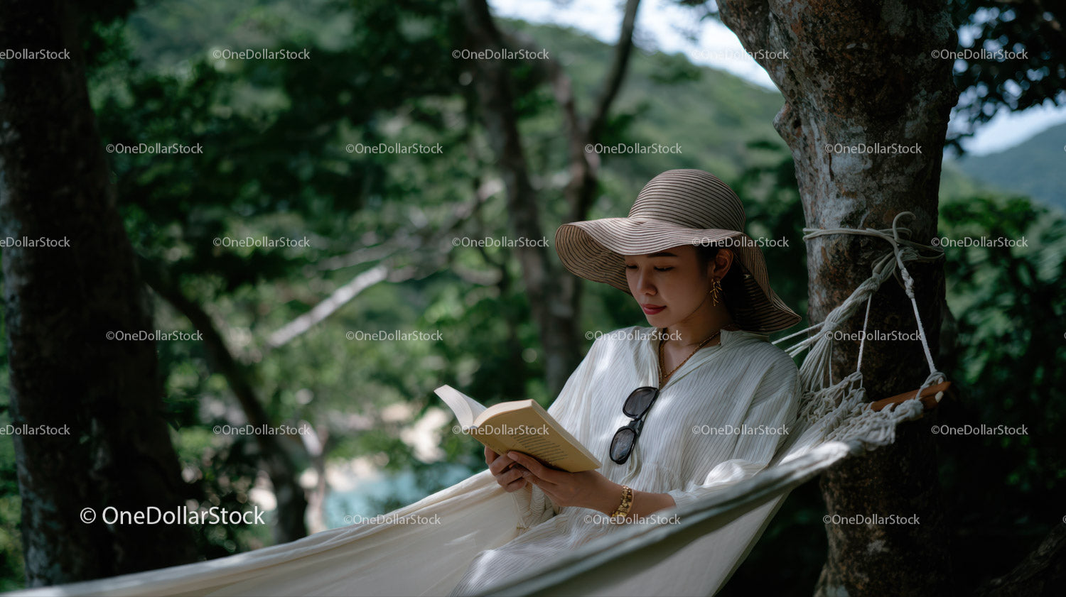 Woman Relaxing in Hammock Reading in Green Forest Scene