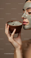 Woman with Green Clay Facial Mask Applying Skincare for Rejuvenation