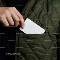 Hand placing blank card into quilted jacket pocket