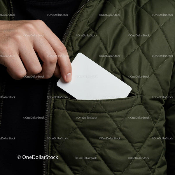 Hand placing blank card into quilted jacket pocket JPG Mockup Image
