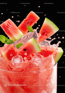 Refreshing watermelon pieces splashing in cold drink