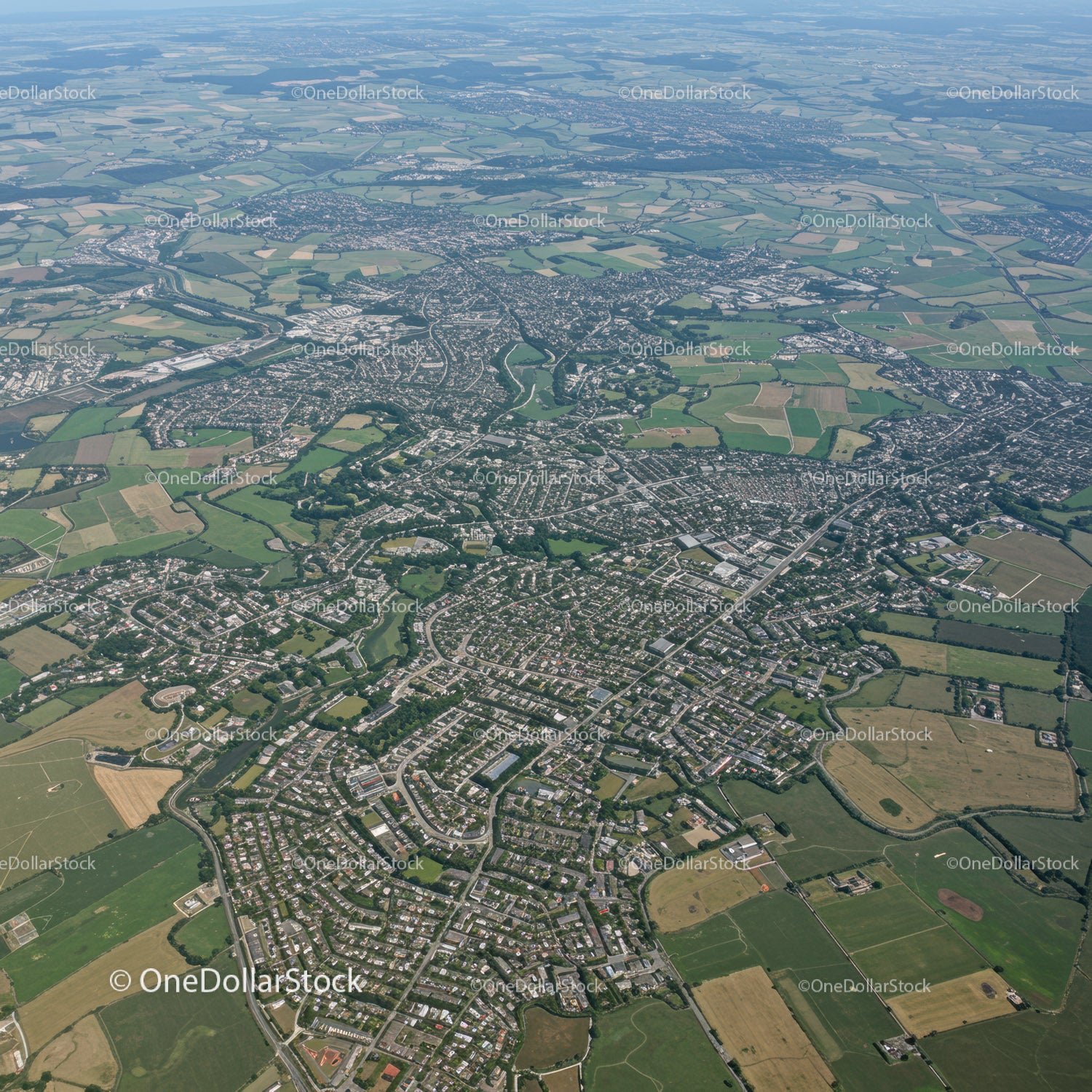 Aerial View of Suburban Cityscape with Green Spaces and Road Network