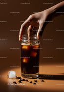 Hand reaching for glass of iced cold brew coffee