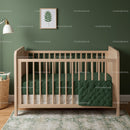 Modern Baby Crib with Green Bedding and Natural Wood Finish
