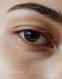 Close-up of natural brown eye with detailed skin texture