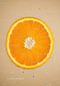 Fresh orange slice with water droplets in soft light