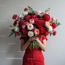 Person Holding Large Vibrant Bouquet of Mixed Flowers