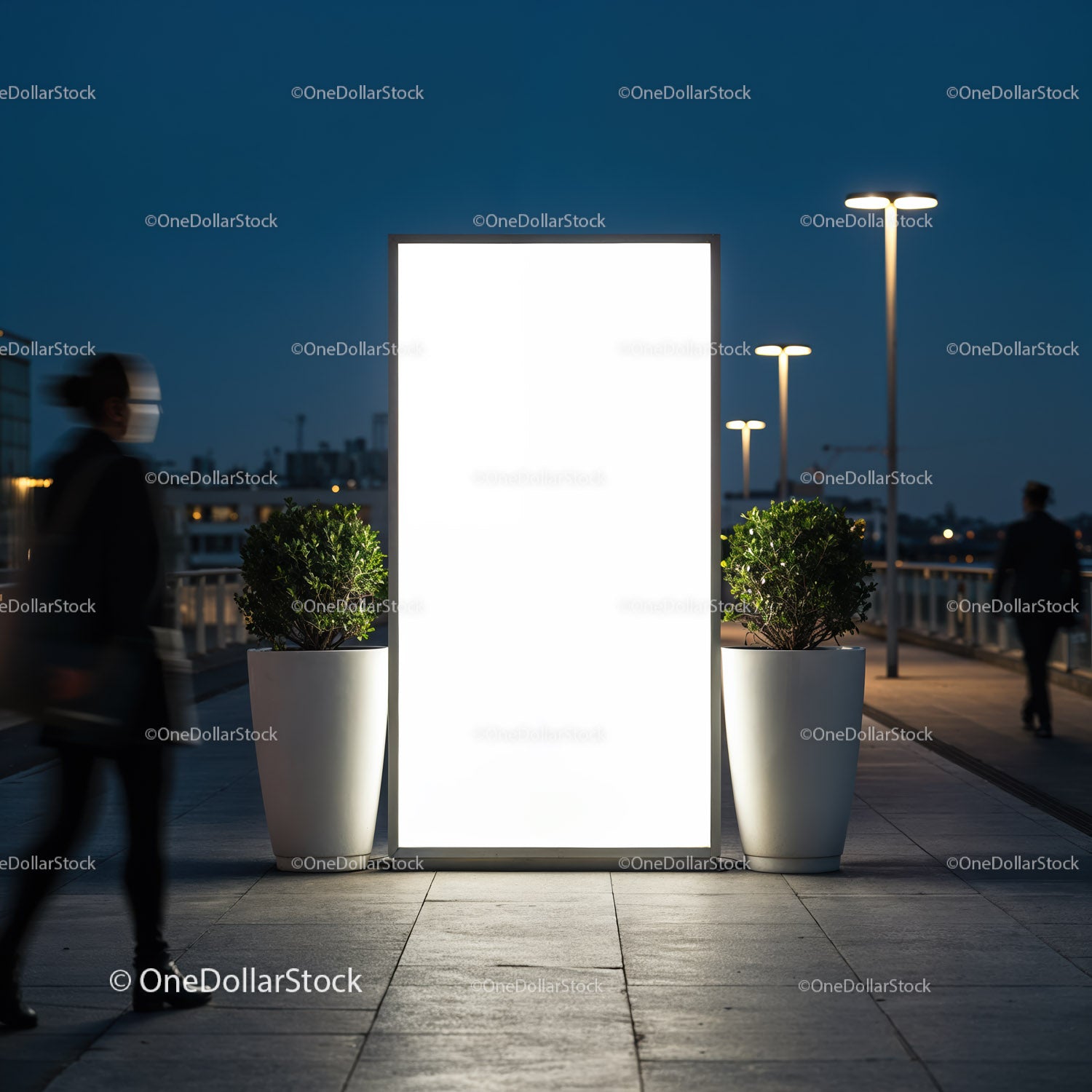 Illuminated urban billboard with pedestrians passing by