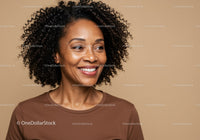 Confident Woman with Curly Hair Wearing Brown Top in Indoor Portrait