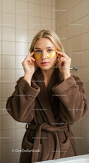 Young Woman Applying Eye Mask in Bathroom for Skincare Routine