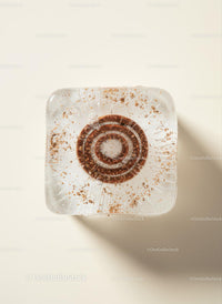Close up of icy coffee cube with espresso concentrate