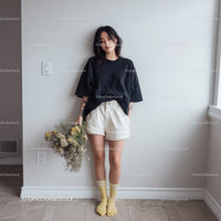 Young Woman in Casual Outfit Holding Bouquet in Minimalist Interior
