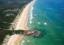 Scenic Coastal Beach with Clear Ocean Waves and Lush Greenery