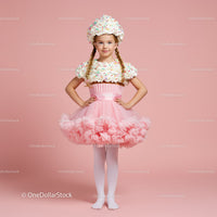 Little girl in pink tutu and whipped cream costume