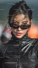 Confident Woman in Black Leather Outfit and Stylish Sunglasses