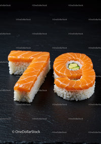Numbers 7 and 9 crafted from fresh sushi on black slate