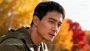 Thoughtful Asian man outdoors in autumn sunlight
