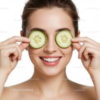 Woman Holding Cucumber Slices Over Eyes for Natural Spa Relaxation