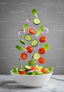 Fresh mixed vegetable salad with flying ingredients