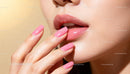 Glossy lips and pastel pink manicure close-up