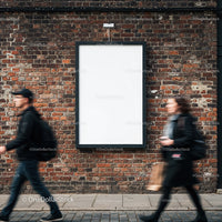 Empty vertical billboard on brick wall with walking people