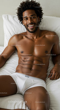 Smiling man relaxing in white underwear on bed