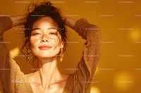 Young Woman with Freckles and Curly Hair in Golden Background