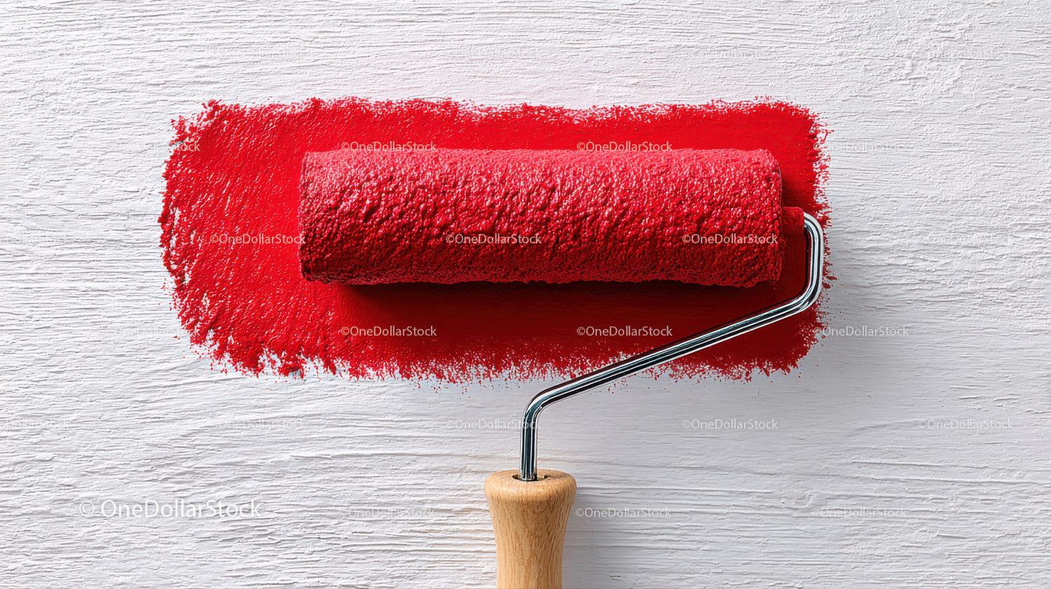 Red Paint Roller Applying Bright Color to Wall